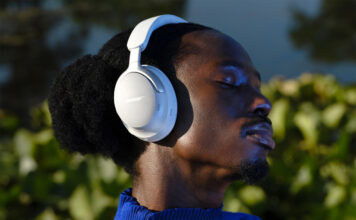 Man wearing Bose QuietComfort Ultra headphones in white.