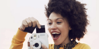 Woman taking photo with instant camera