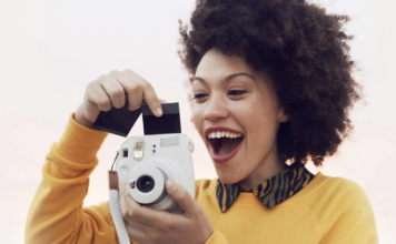 Woman taking photo with instant camera