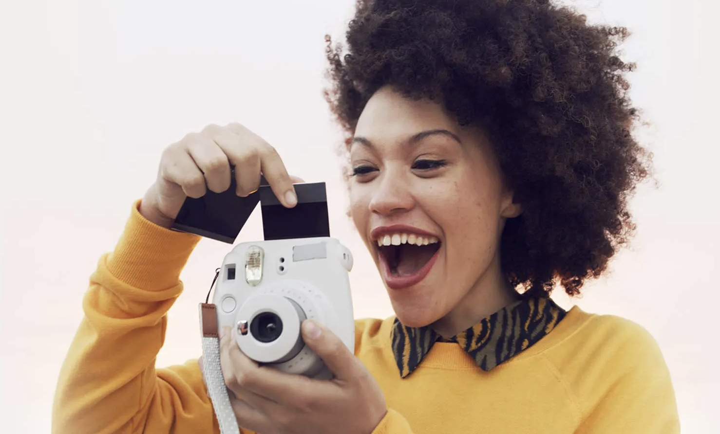 Woman taking photo with instant camera