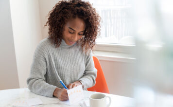 Woman writing in a birthday card