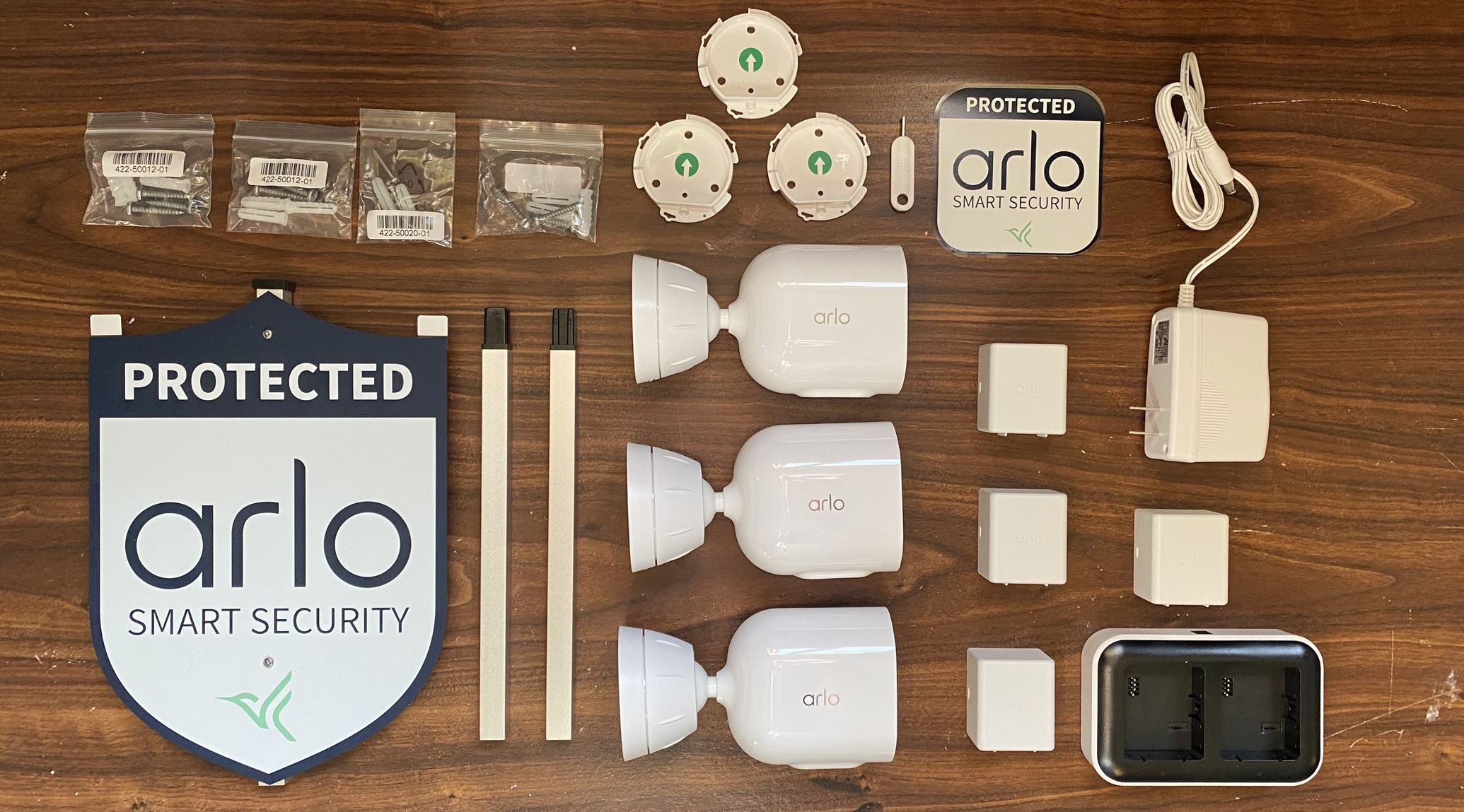 Arlo Pro 5S three camera pack fully unboxed on a table.