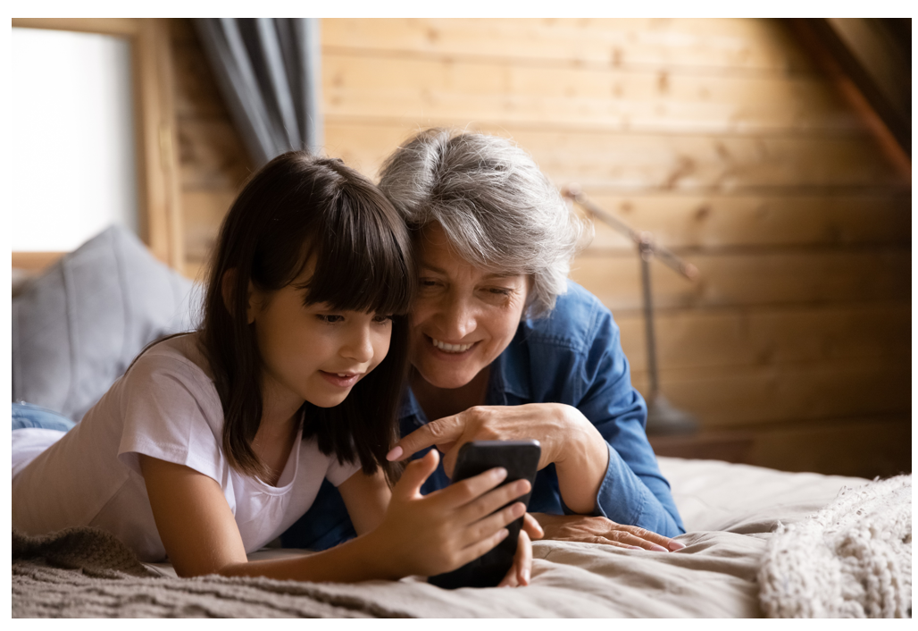 young girl and older woman looking at a smartphone.