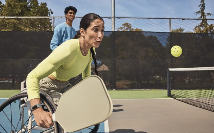 Fitbit Charge 6 on a woman playing pickleball in a wheelchair