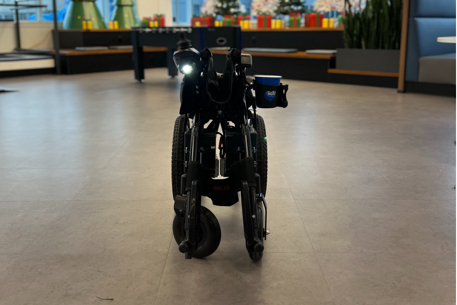 Black electric wheelchair folded up with LED light on.