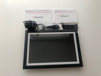 Aluratek digital photo frame unboxed with accessories. 