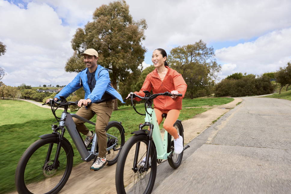 Two people riding the Velotric Discover e-bikes