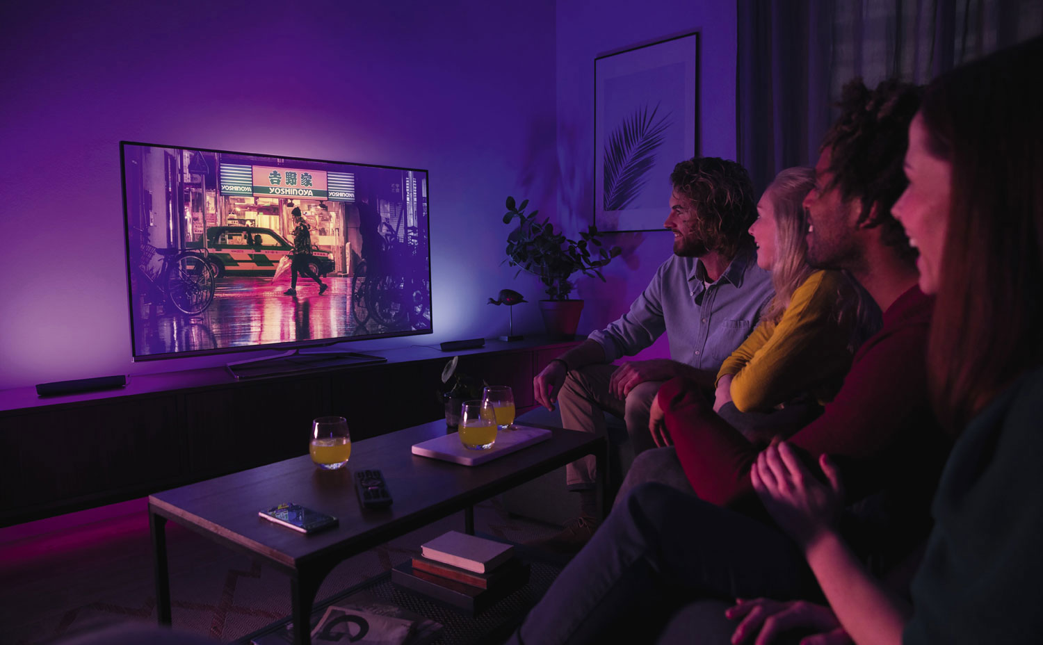 a group of people watching TV on a big screen