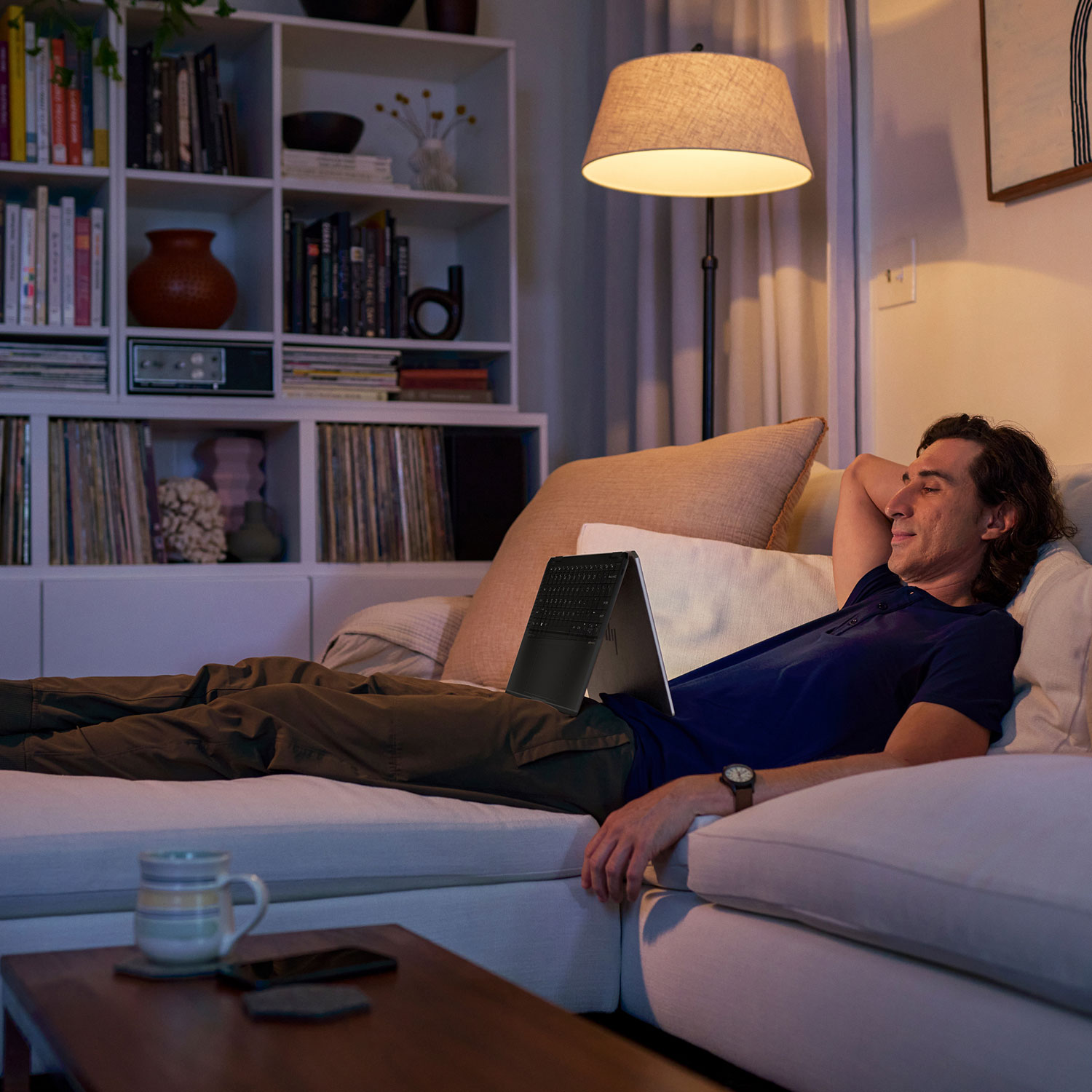 A man watching something on a HP Spectre x360 laptop