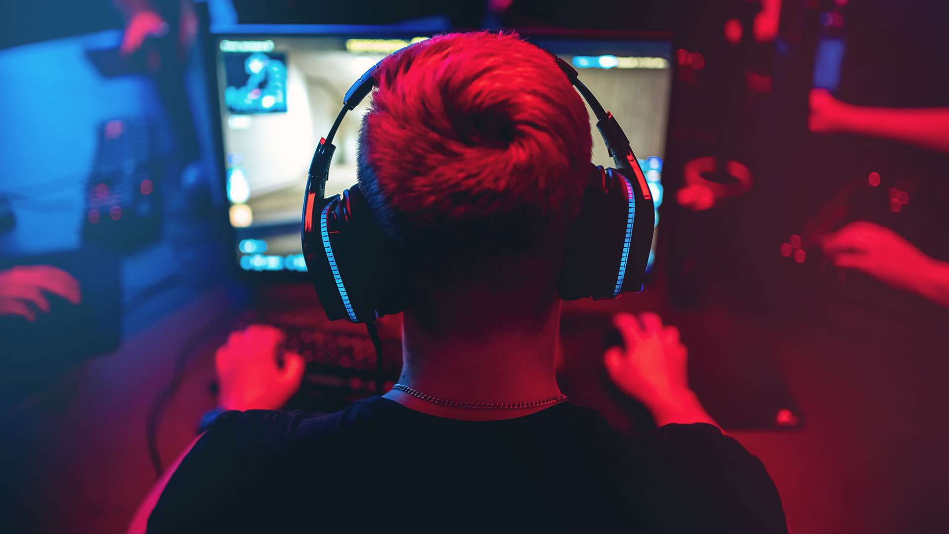 A boy playing games on the PC with headphones