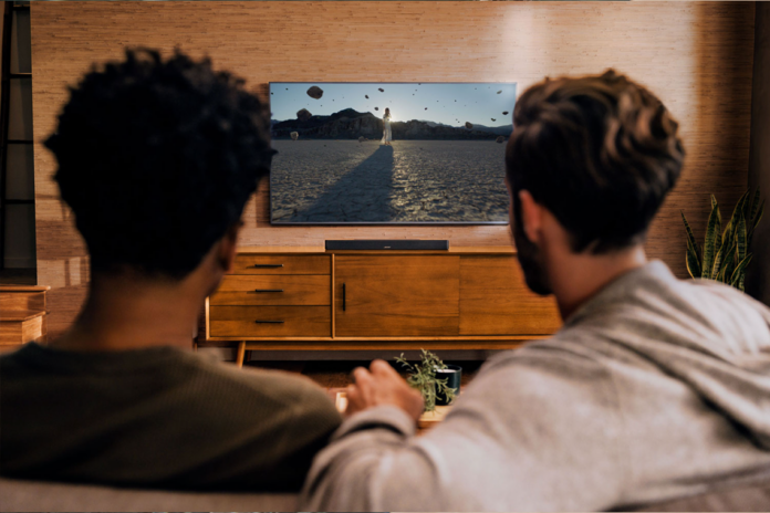 two man watching looking at TV setup with smart TV accessories