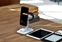 Smartphone, smartwatch and earbuds charging on a wireless stand