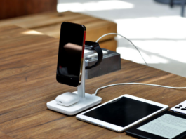 Smartphone, smartwatch and earbuds charging on a wireless stand