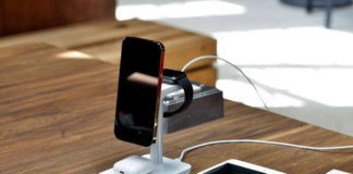 Smartphone, smartwatch and earbuds charging on a wireless stand