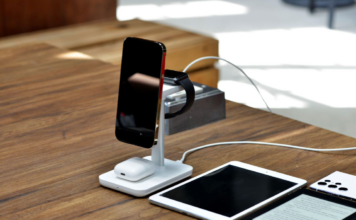 Smartphone, smartwatch and earbuds charging on a wireless stand