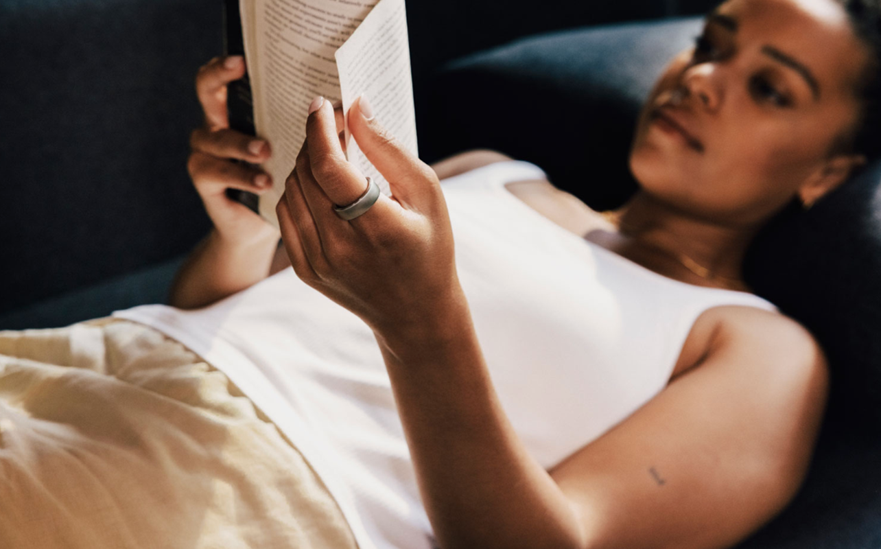 Woman wearing Oura ring while relaxing