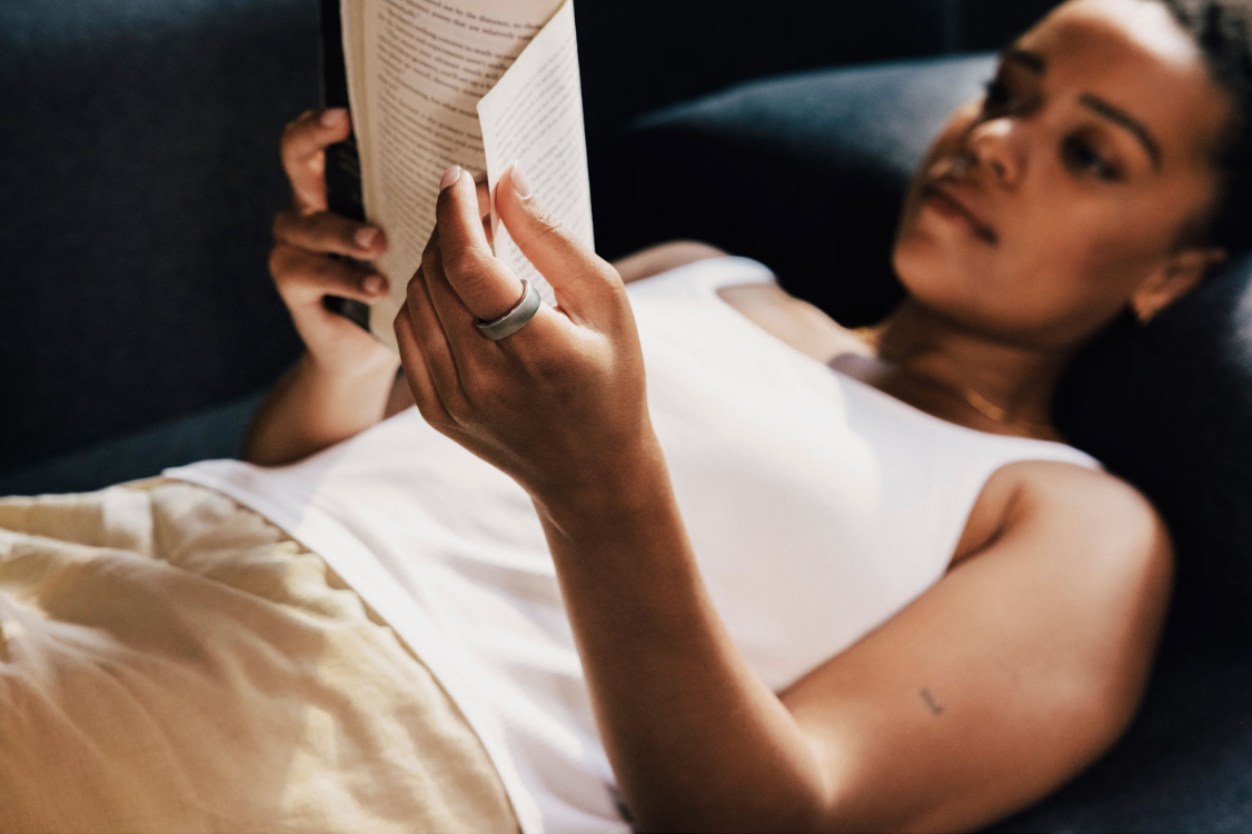 Woman wearing Oura ring while relaxing