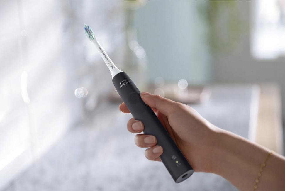 Philips Sonicare 4100 electric toothbrush in hand