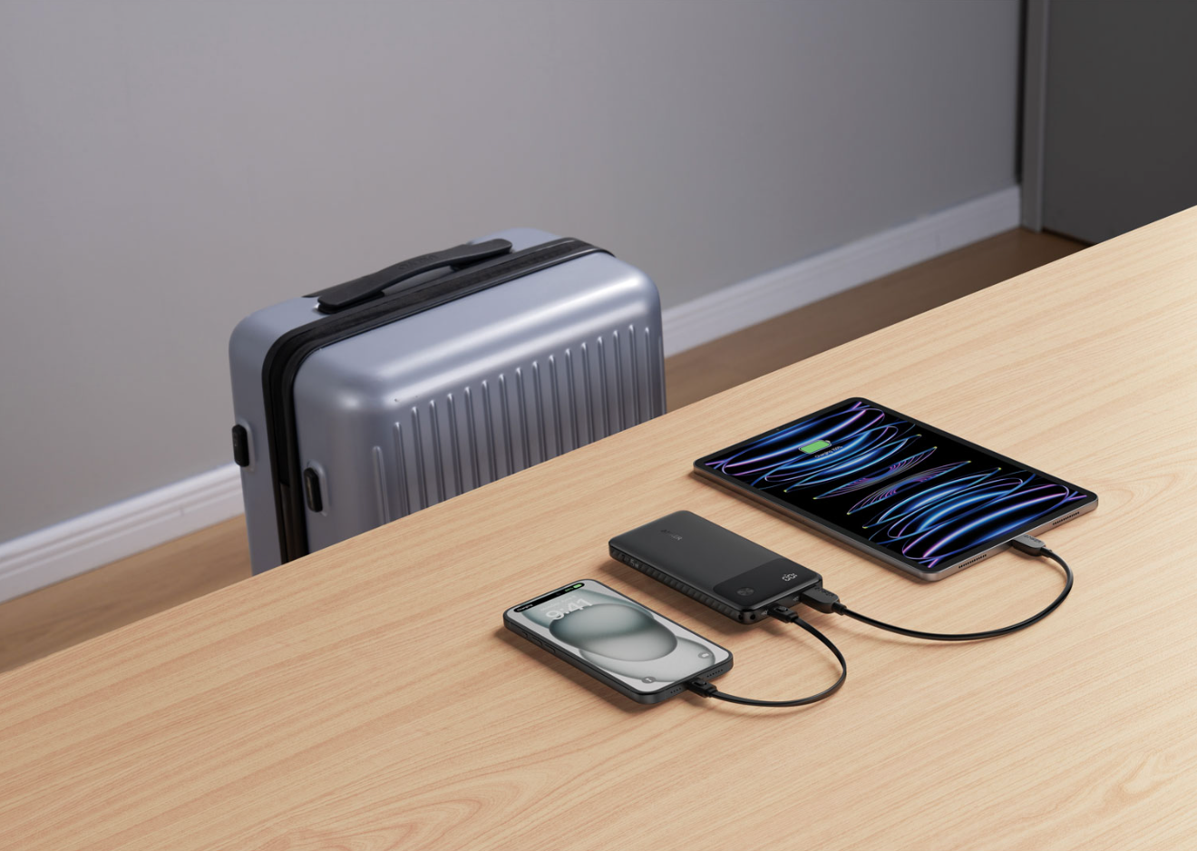 Power bank charging a smartphone and tablet on the go