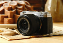 Fujifilm X-M5 resting on a table near food.