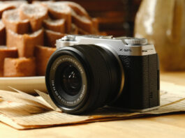 Fujifilm X-M5 resting on a table near food.