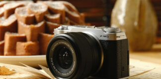 Fujifilm X-M5 resting on a table near food.