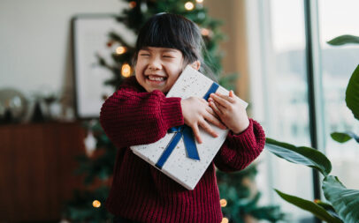 Jeune fille serrant un cadeau dans ses bras