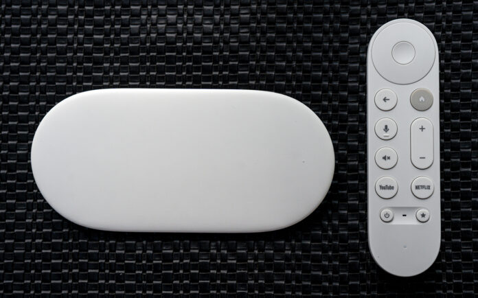 Google TV Streamer box next to remote.