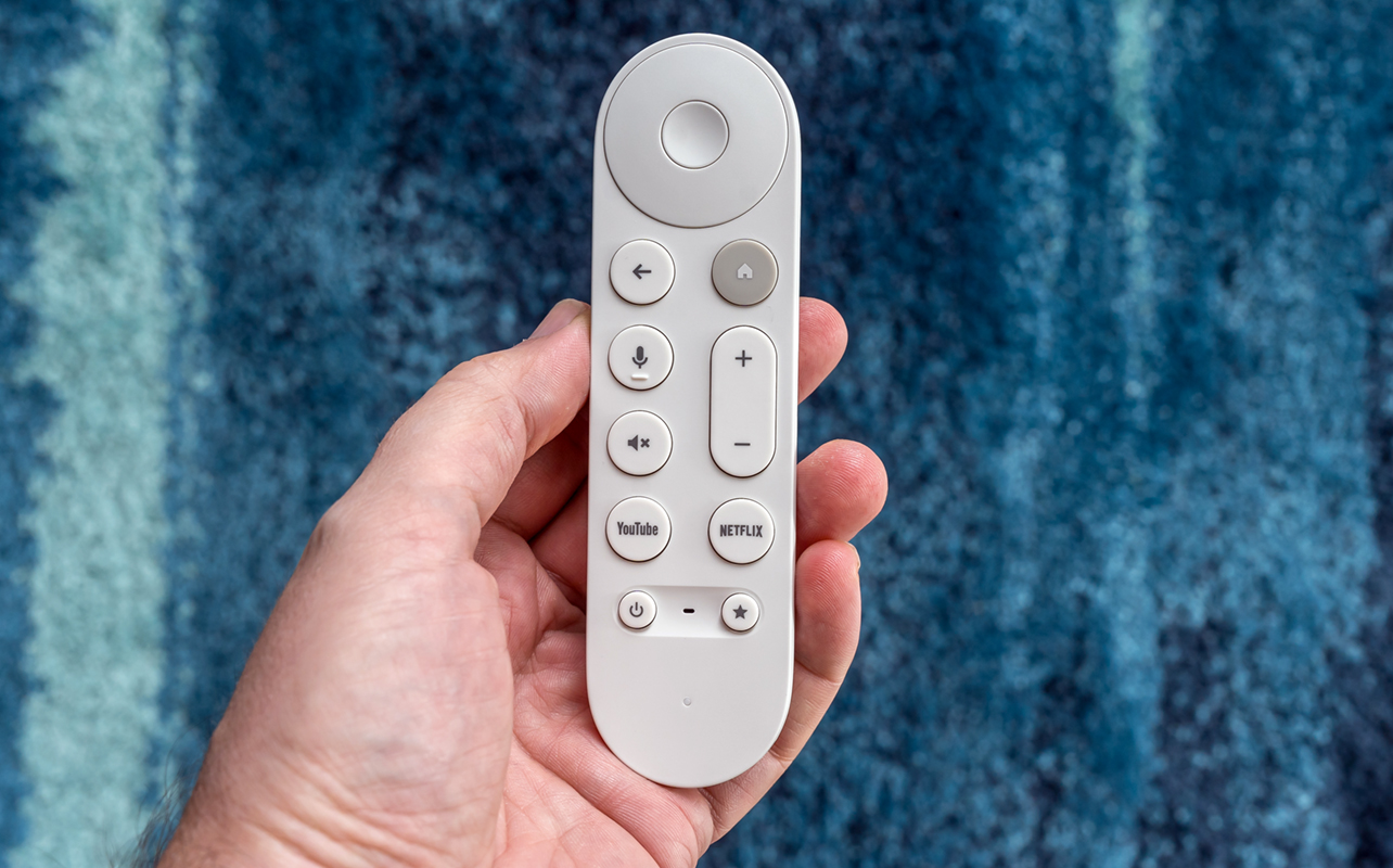 Google TV Streamer remote in hand.