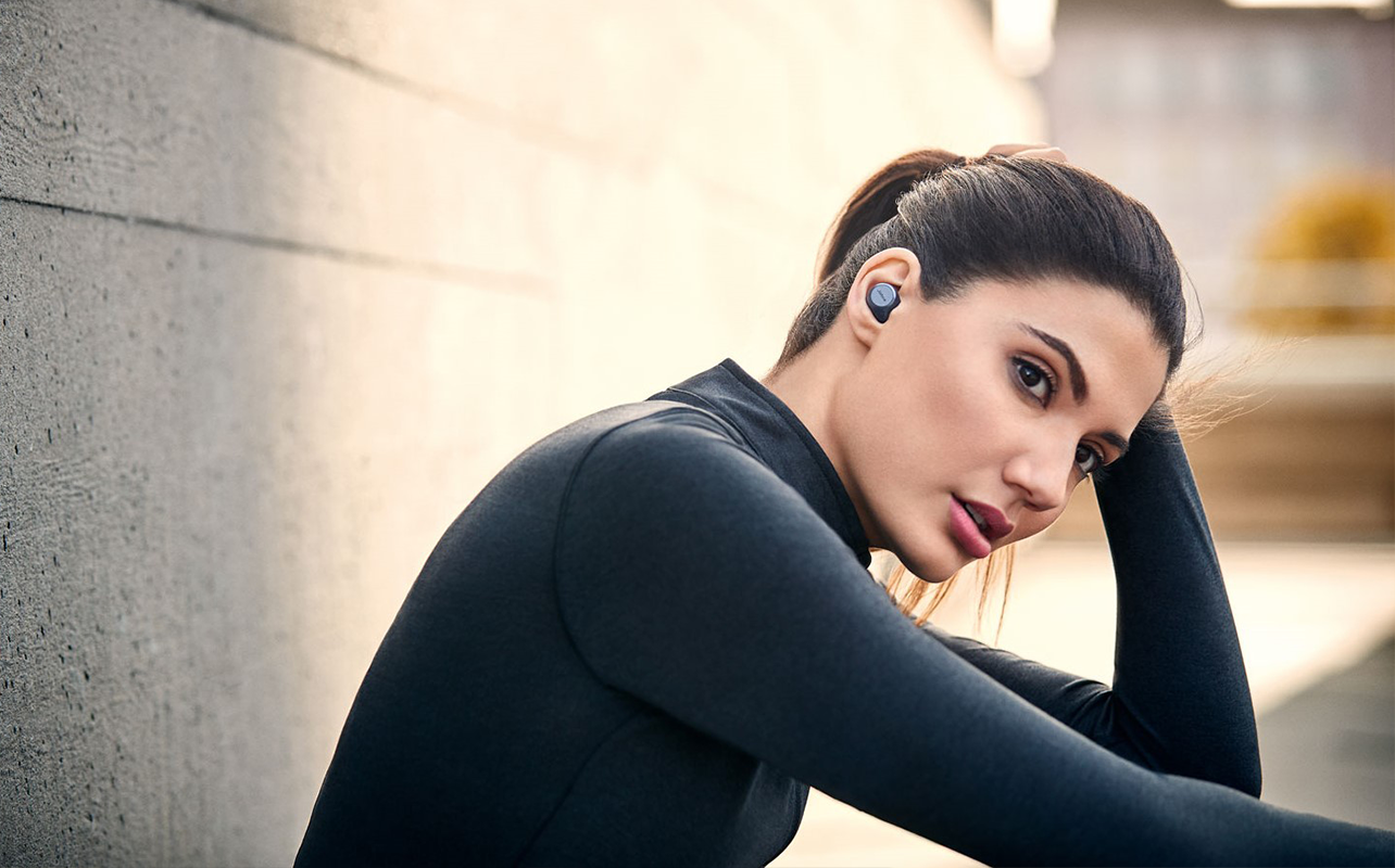 Woman wearing earbuds when working out