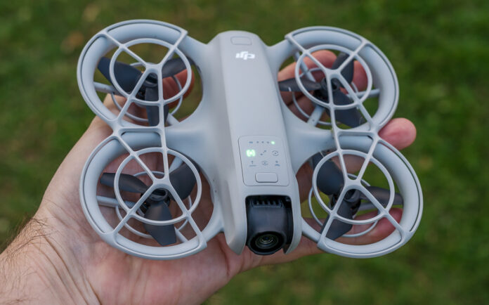 DJI Neo powered on and in palm of hand.