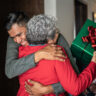 Son greeting mother on christmas at home