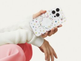 A hand holding an iPhone 16 with the Petite Floral clear Ideal of Sweden phone case against a white background. This person has pink pants and white sleeves but we cannot see their face.