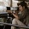 Man shooting with Sony Alpha 1 II outdoors in wildlife.
