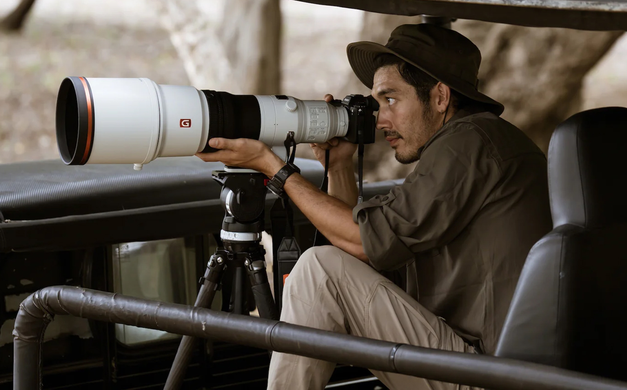 Man shooting with Sony Alpha 1 II outdoors in wildlife.