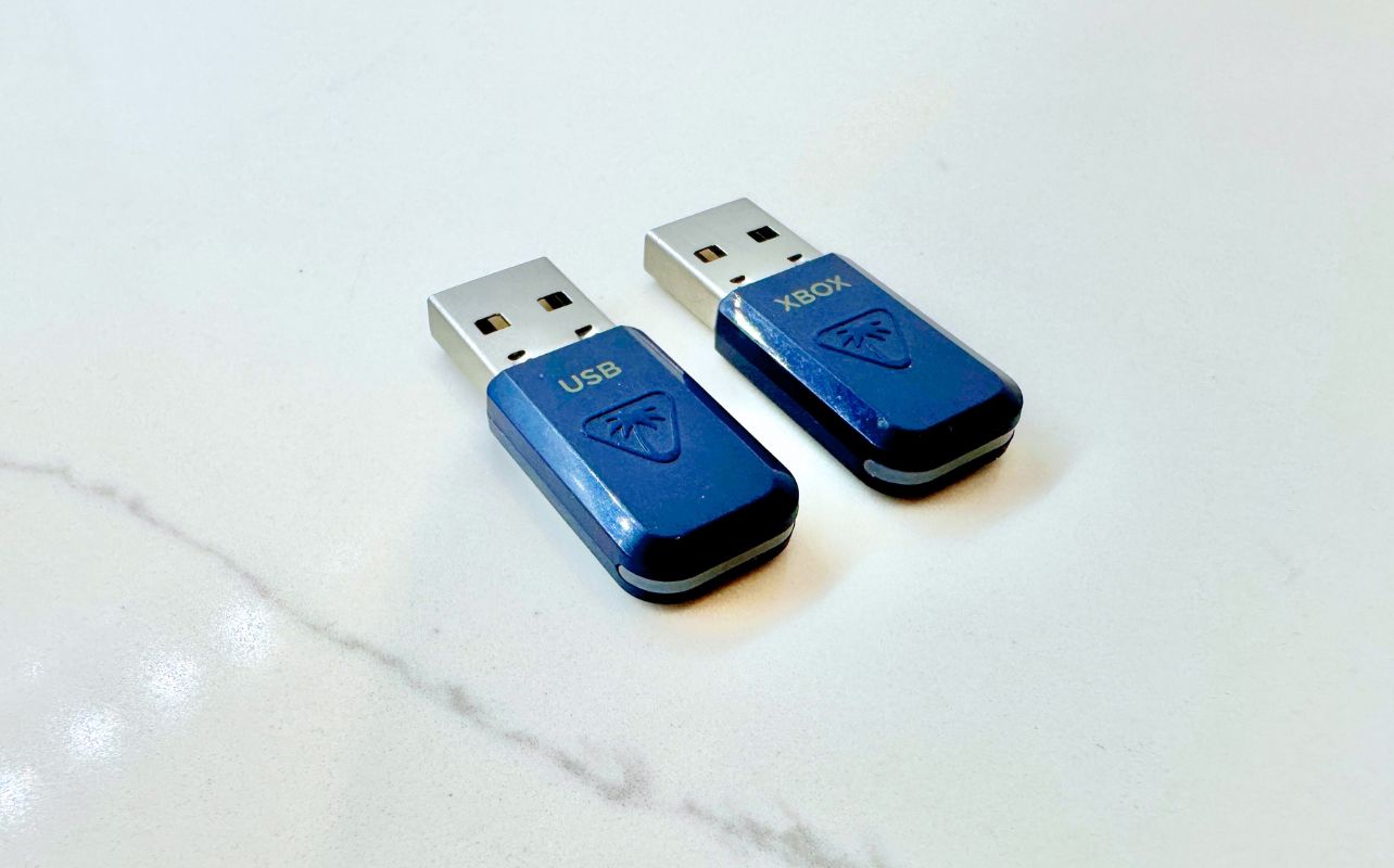 The Turtle Beach Stealth 700 dual USB dongles side-by-side on a white surface.