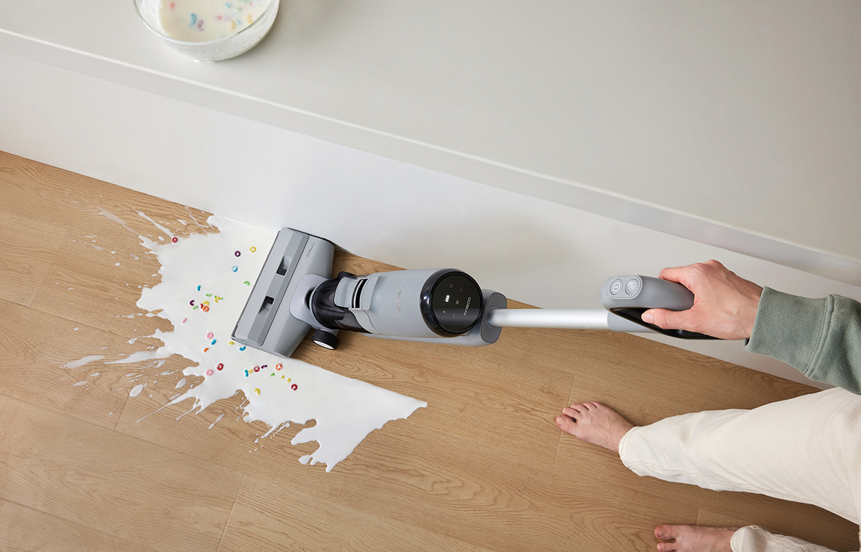 Man cleaning spill in kitchen with Tineco GO H2O XL.