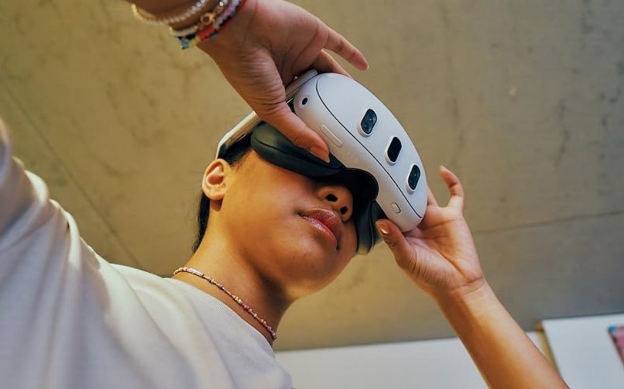 Women wearing a Meta Quest 3 adjusting the headset for comfort.