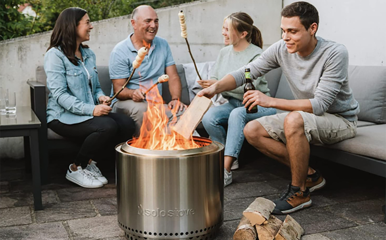 A family around a Solo Stove roasting marshmallows