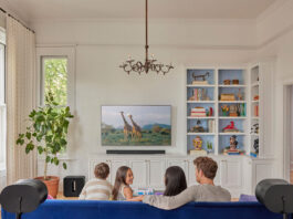 Family in the living room with Sonos Arc soundbar.