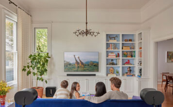 Family in the living room with Sonos Arc soundbar.