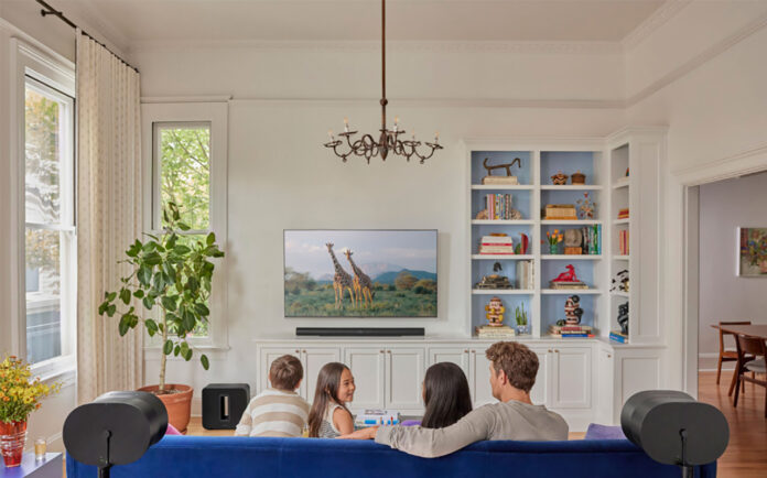 Family in the living room with Sonos Arc soundbar.