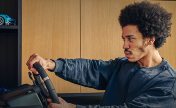 Man playing a video game with the Logitech G29 Driving Force Racing Wheel