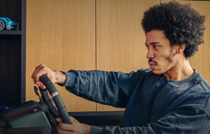 Man playing a video game with the Logitech G29 Driving Force Racing Wheel