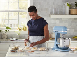 Woman with a KitchenAid stand mixer