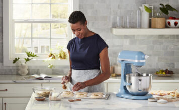 Woman with a KitchenAid stand mixer