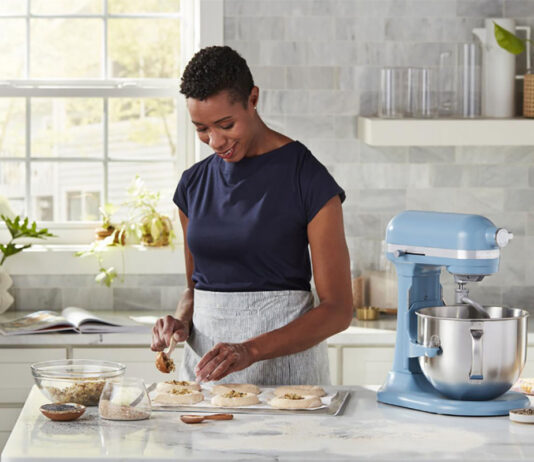 Woman with a KitchenAid stand mixer