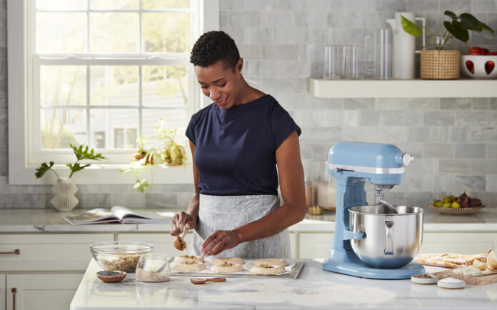 Woman with a KitchenAid stand mixer