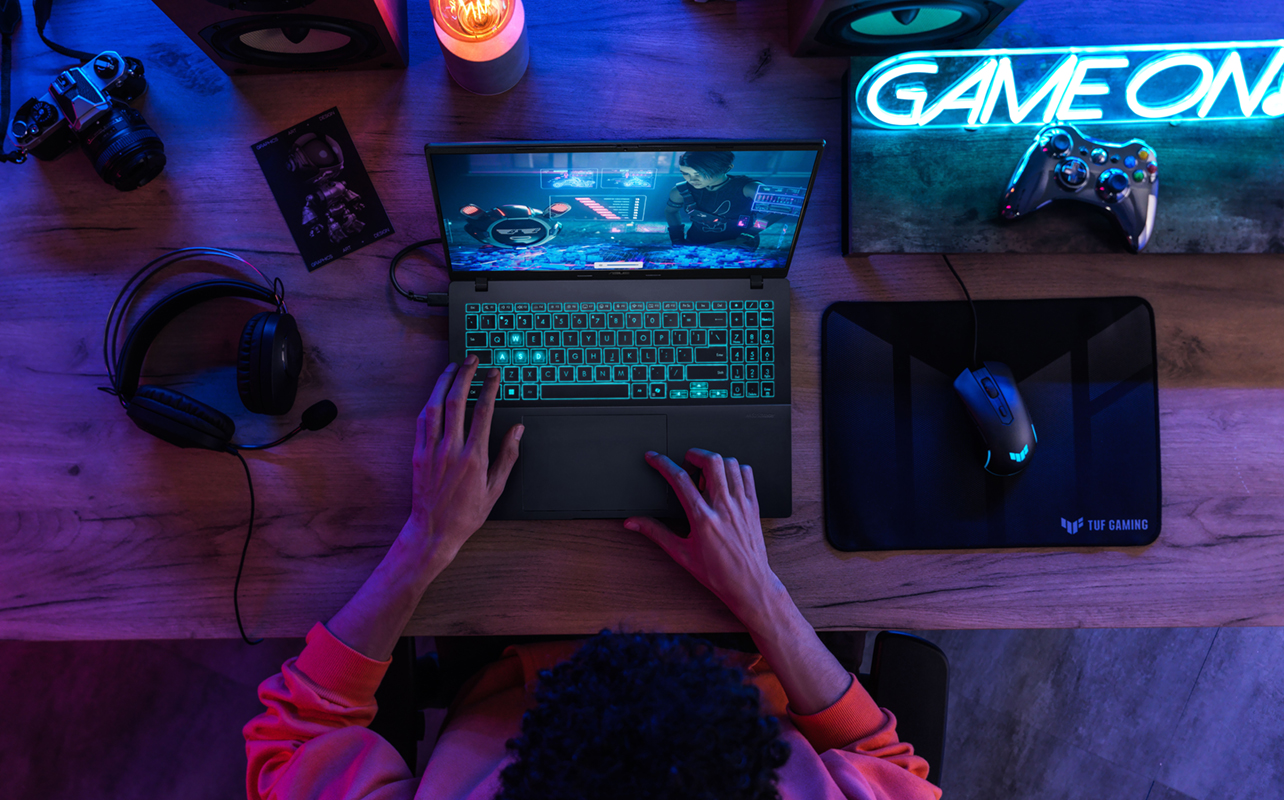 Teenager playing games on a Windows PC laptop.