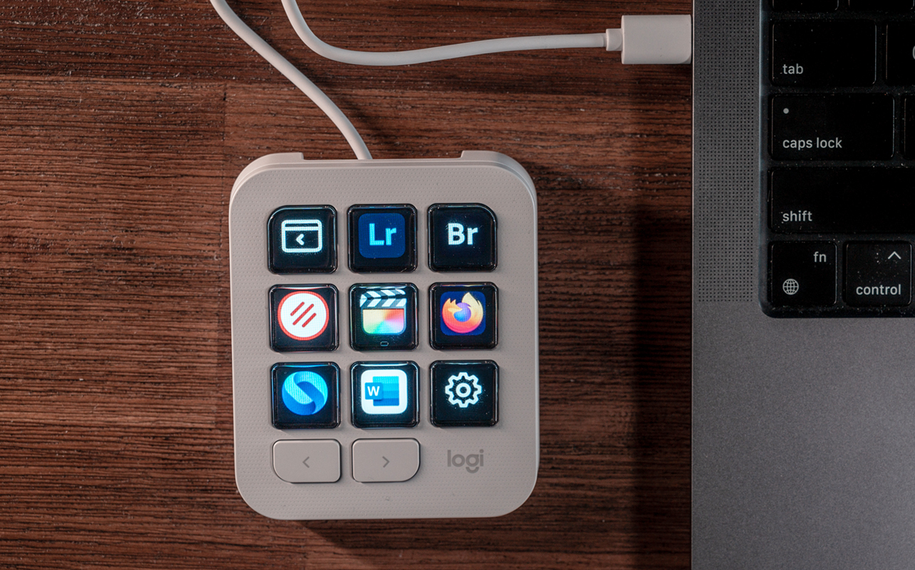 Logitech MX Creative Console Keypad displaying apps on buttons.